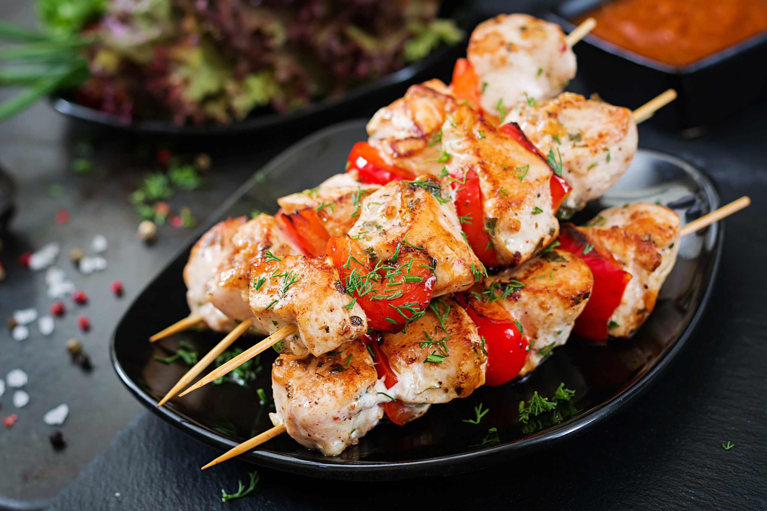 Chicken skewers with slices of sweet peppers and dill. Tasty food. Weekend meal.